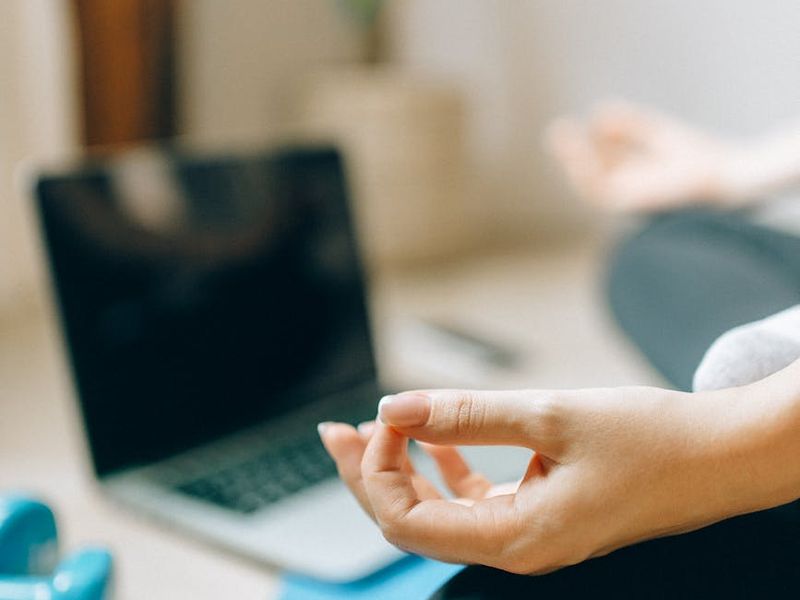 A spacious, well-lit room with a yoga mat on the floor.